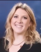 Portrait of a woman with blonde hair smiling.