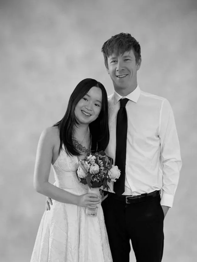 Couple posing for portrait holding flowers