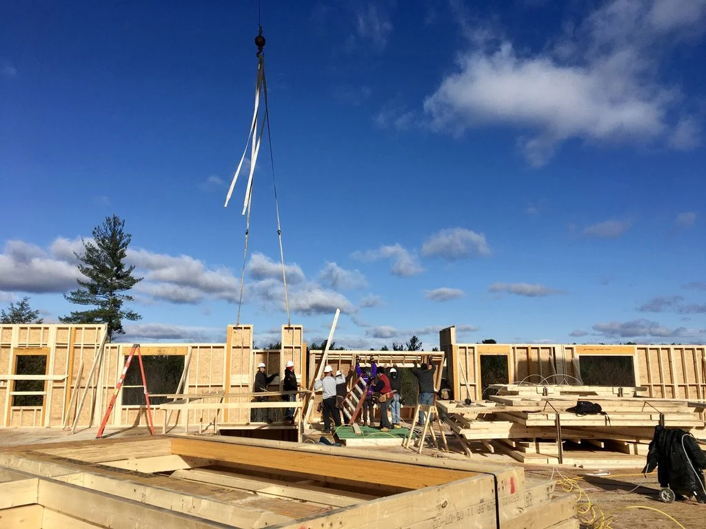 Construction site with workers building a wooden structure