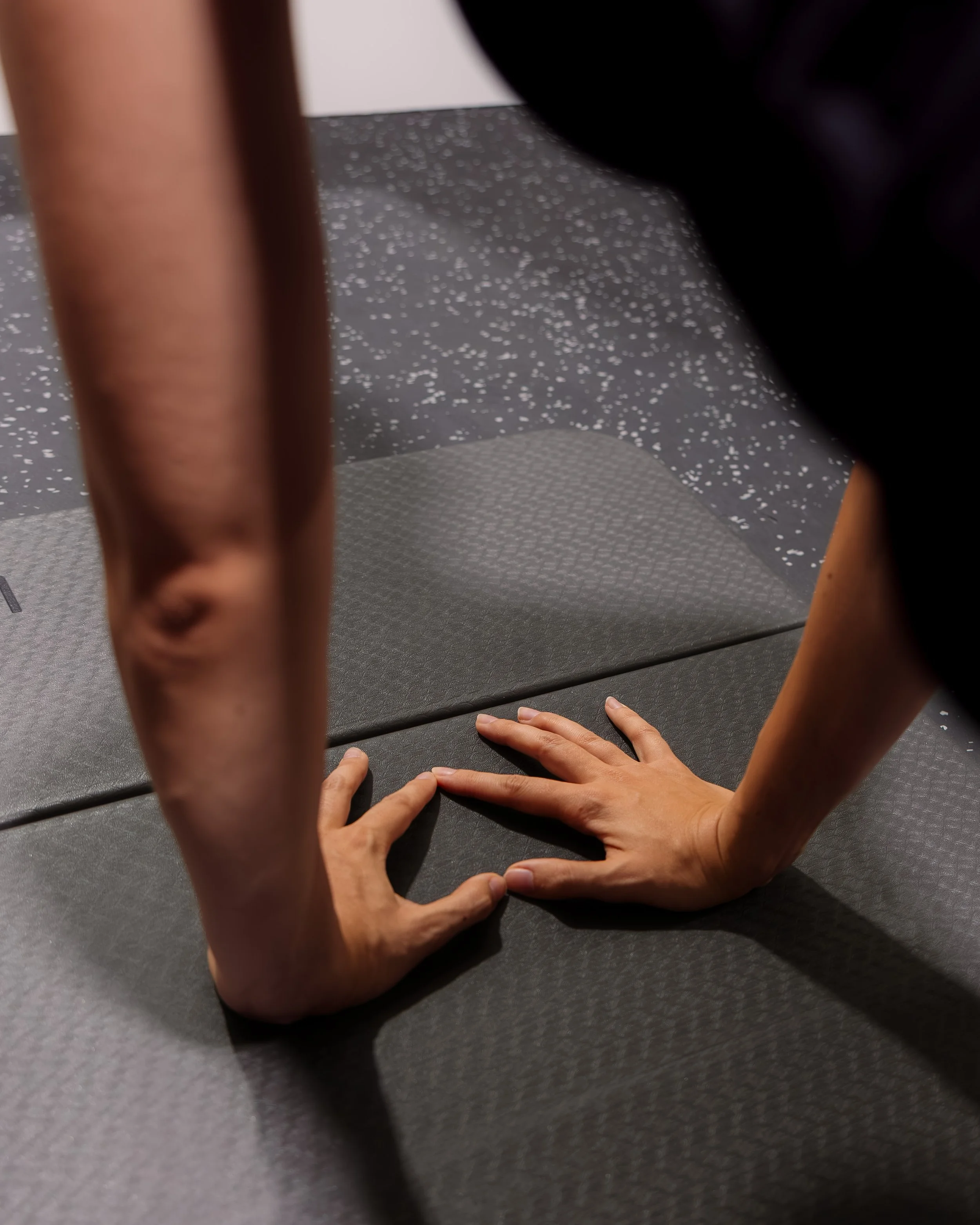 Member performing a push-up during a strength training workout at Milo’s House, a private fitness studio in West Palm Beach, Florida.