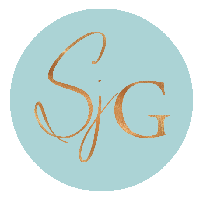 Logo with the initials 'S' and 'G' in gold script on a light blue circular background.