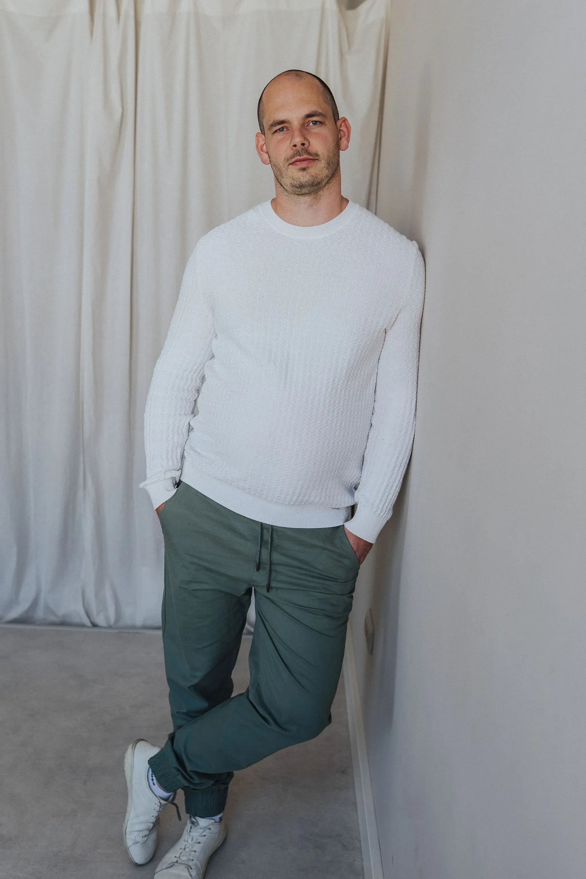 Tim Schröder standing indoors, hands in pockets