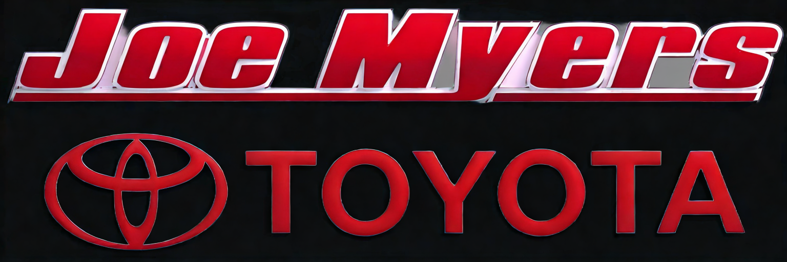 Sign displaying the name 'Joe Myers' at the top and the Toyota logo and name below, both in red on a black background.