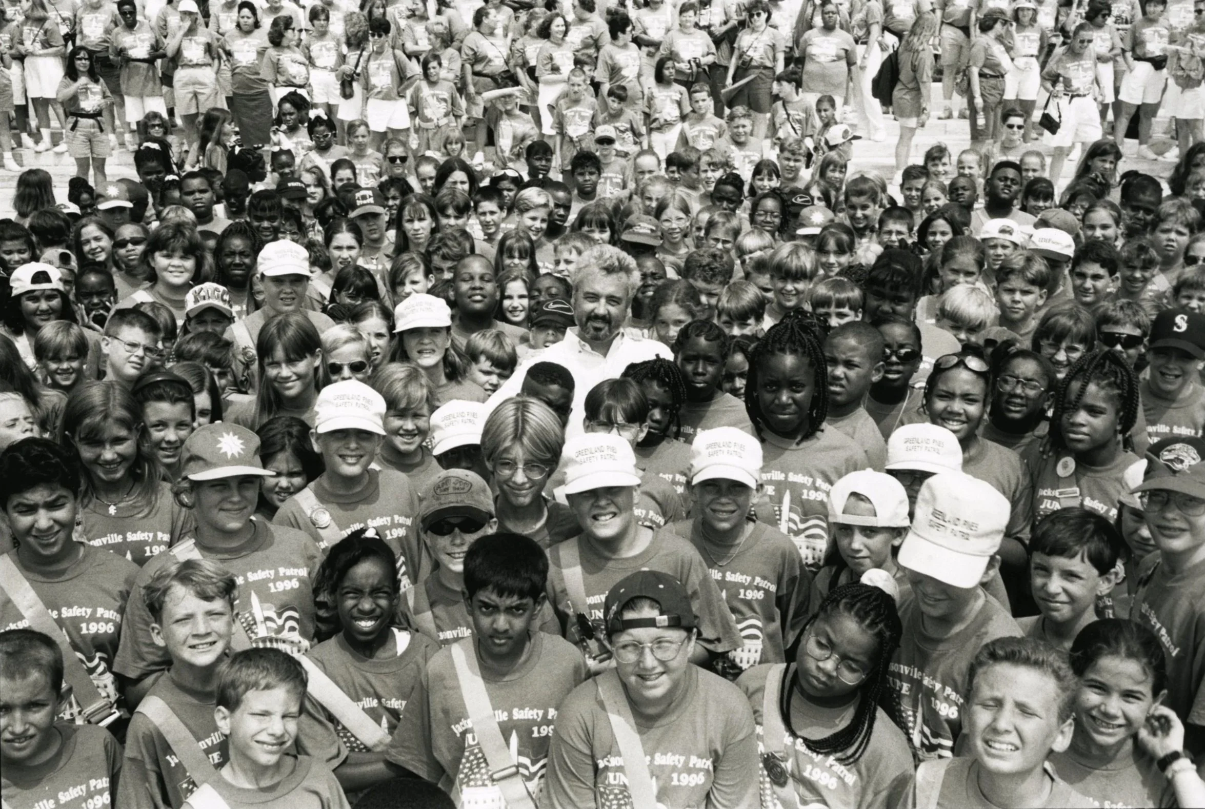 Large group of safety patrol students gathered together for panoramic group photo, black and white background image