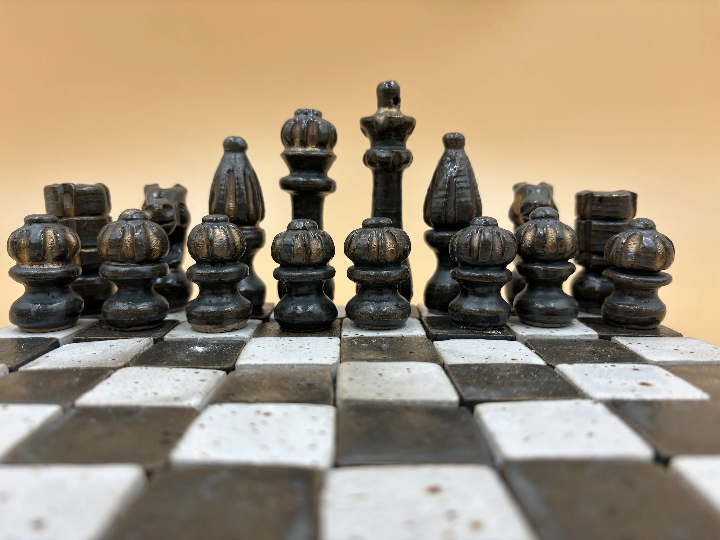 white gold and blue black stoneware chess set