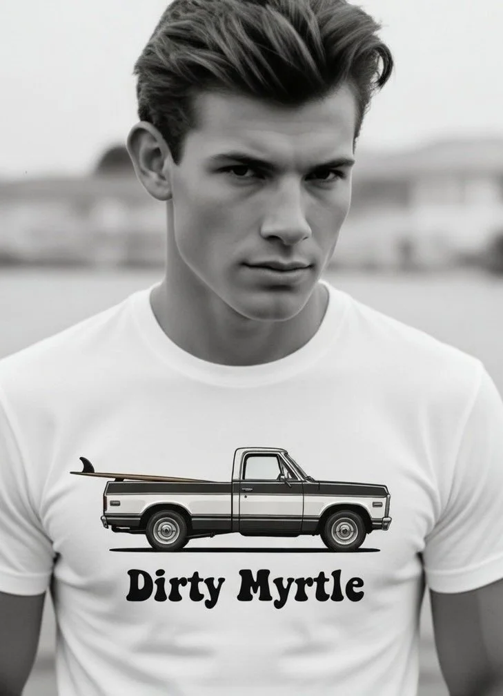 A young man with styled hair is wearing a white T-shirt with a graphic of a pickup truck and the text 'Dirty Myrtle' underneath.