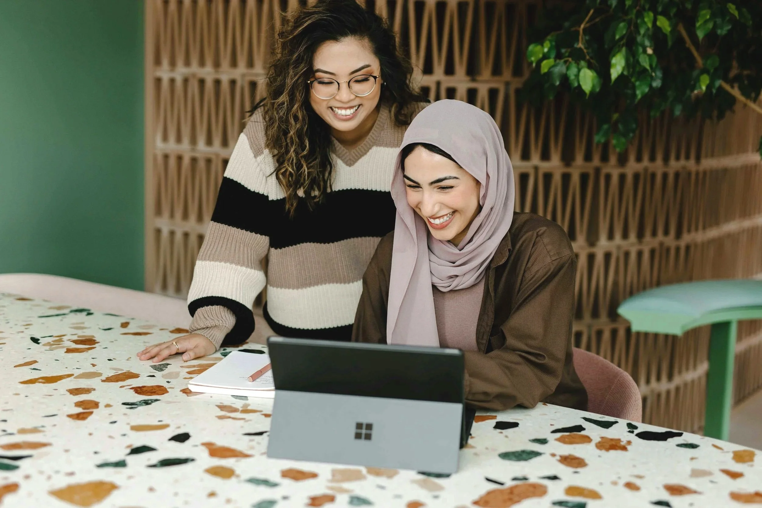 Two colleagues reviewing a project together on a tablet