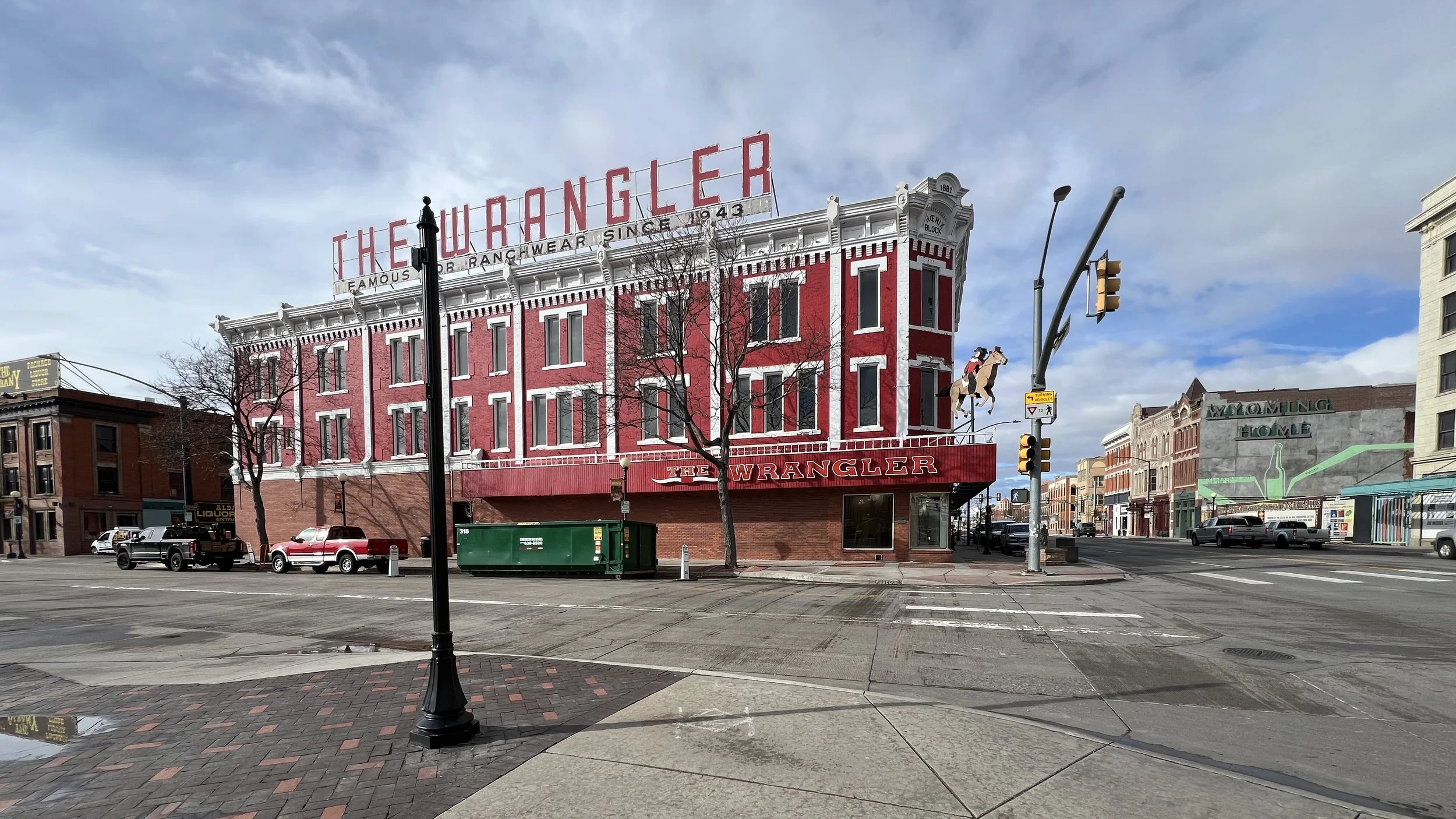 iconic red and white Western Building with "The Wrangler" sign in huge red letters above