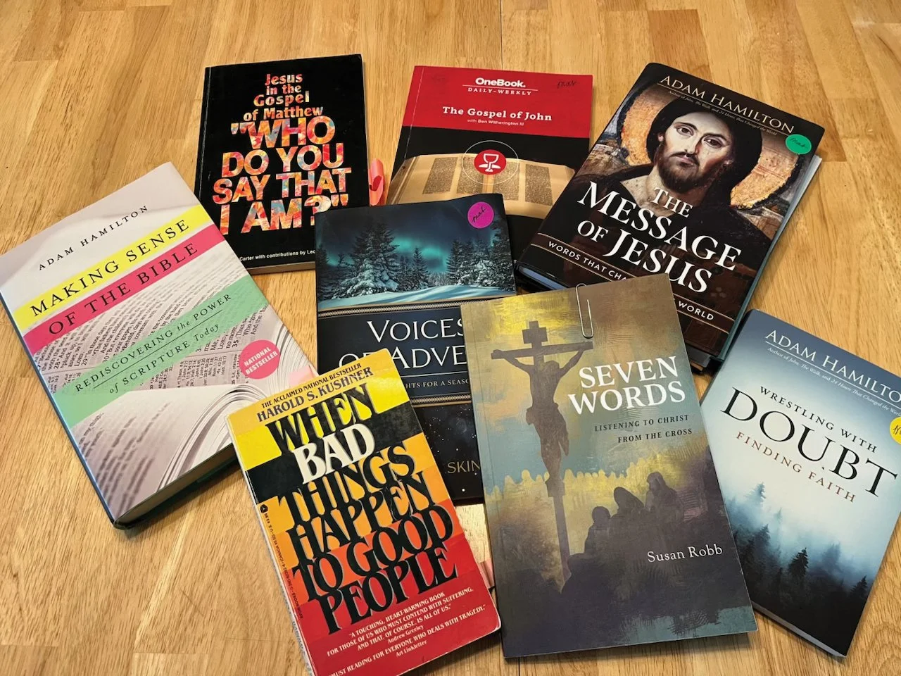A collection of religious and spiritual books for the Adult Insights Sunday School group on a wooden surface, including titles on Jesus, the Bible, Christian listening, faith, and personal growth.