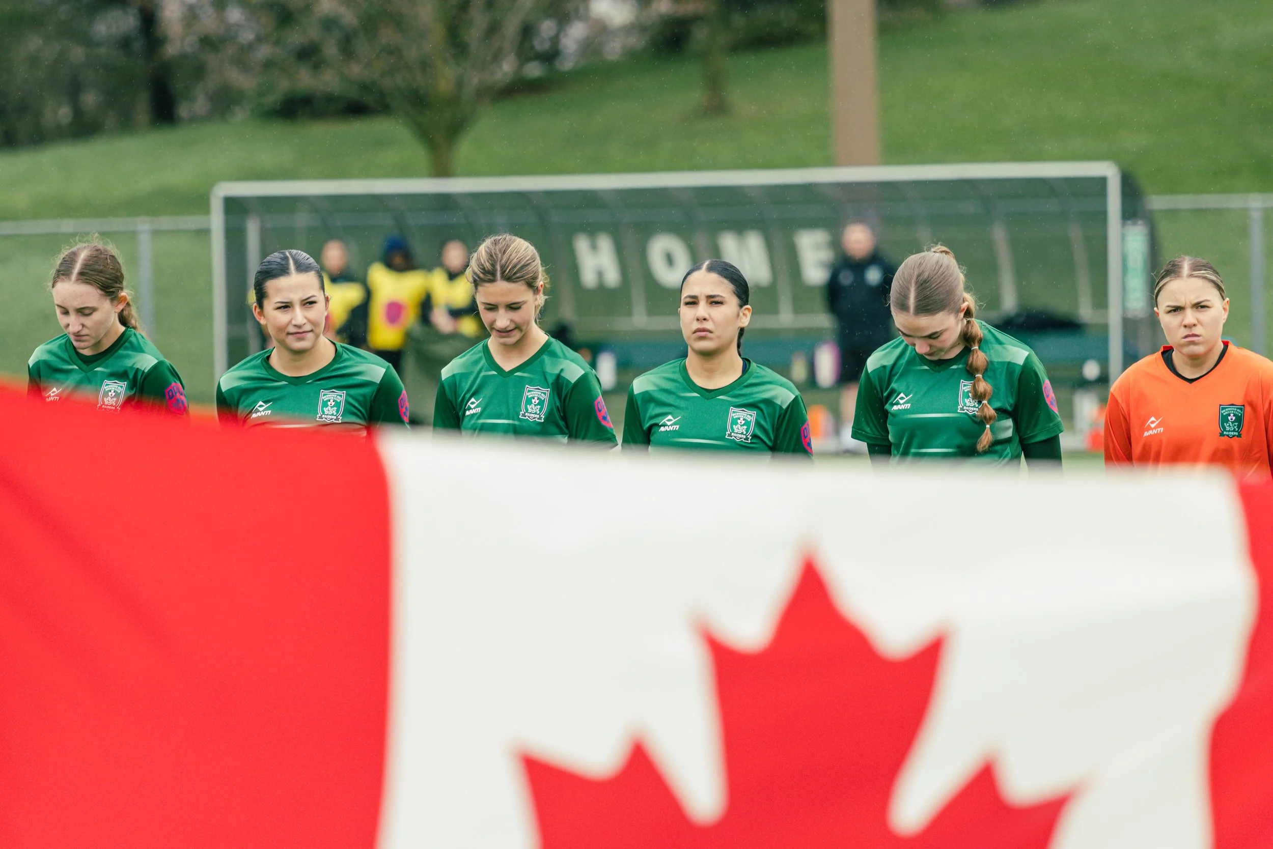 Players line up for the national anthem in the Ontario Premier League.