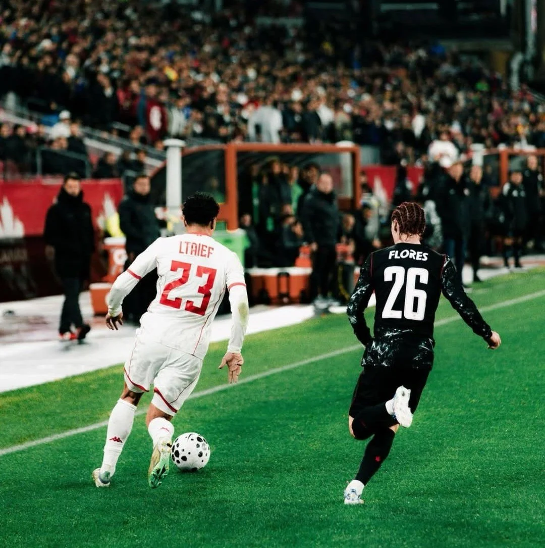 Canada's Marco Flores pursues Sayfallah Ltaief of Tunisia in an international friendly