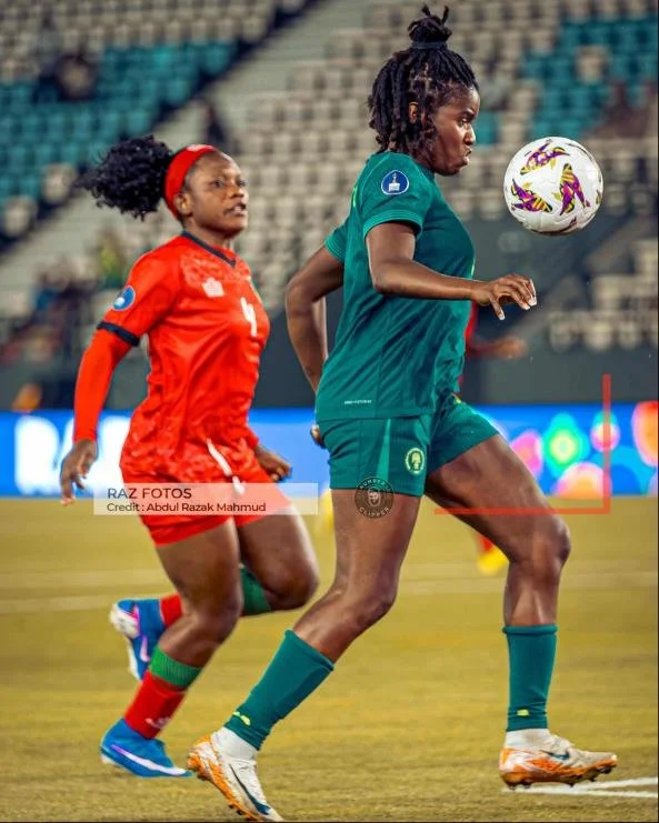 Nigeria's Esther Okoronkwo control the ball as Malawi's Chimwemwe Madise watches on