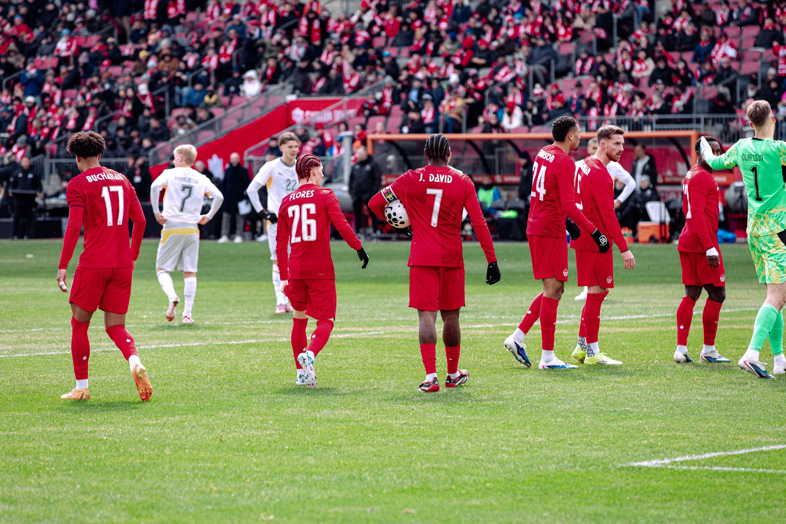 Canada captain Jonathan David takes the ball for a penalty kick against Iceland in a friendly match in Toronto
