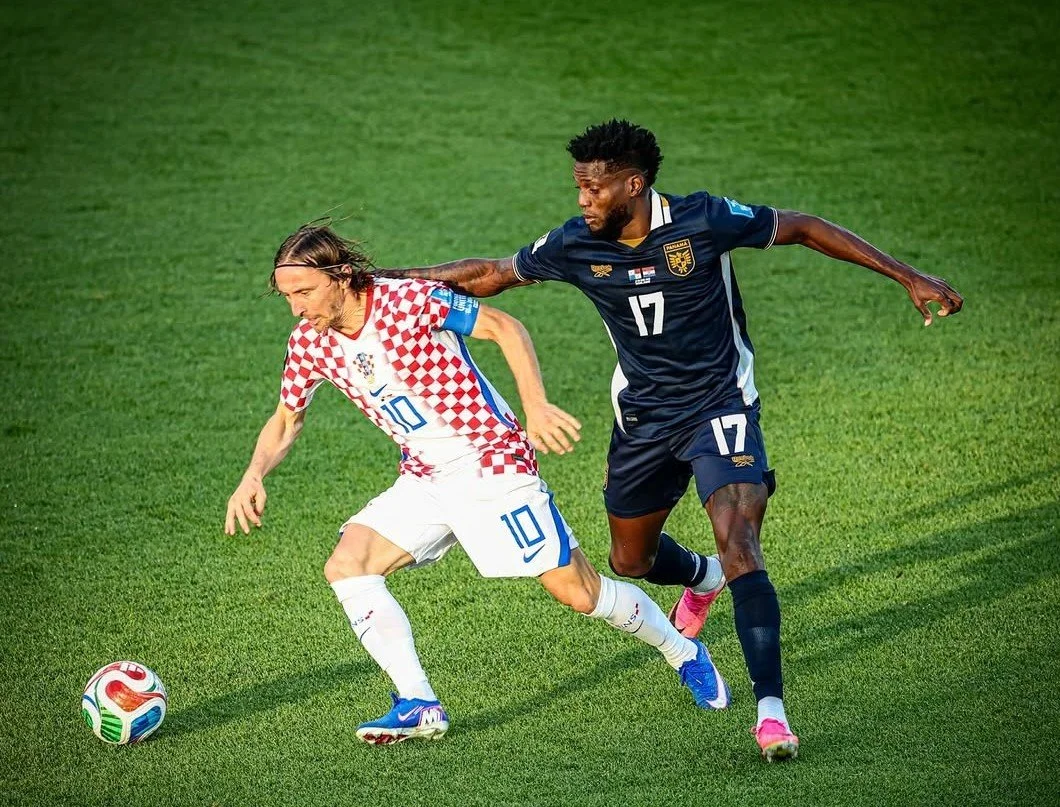 Croatian captain Luka Modrić holds off Jose Fajardo of Panama in a World Cup 2026 match in Toronto