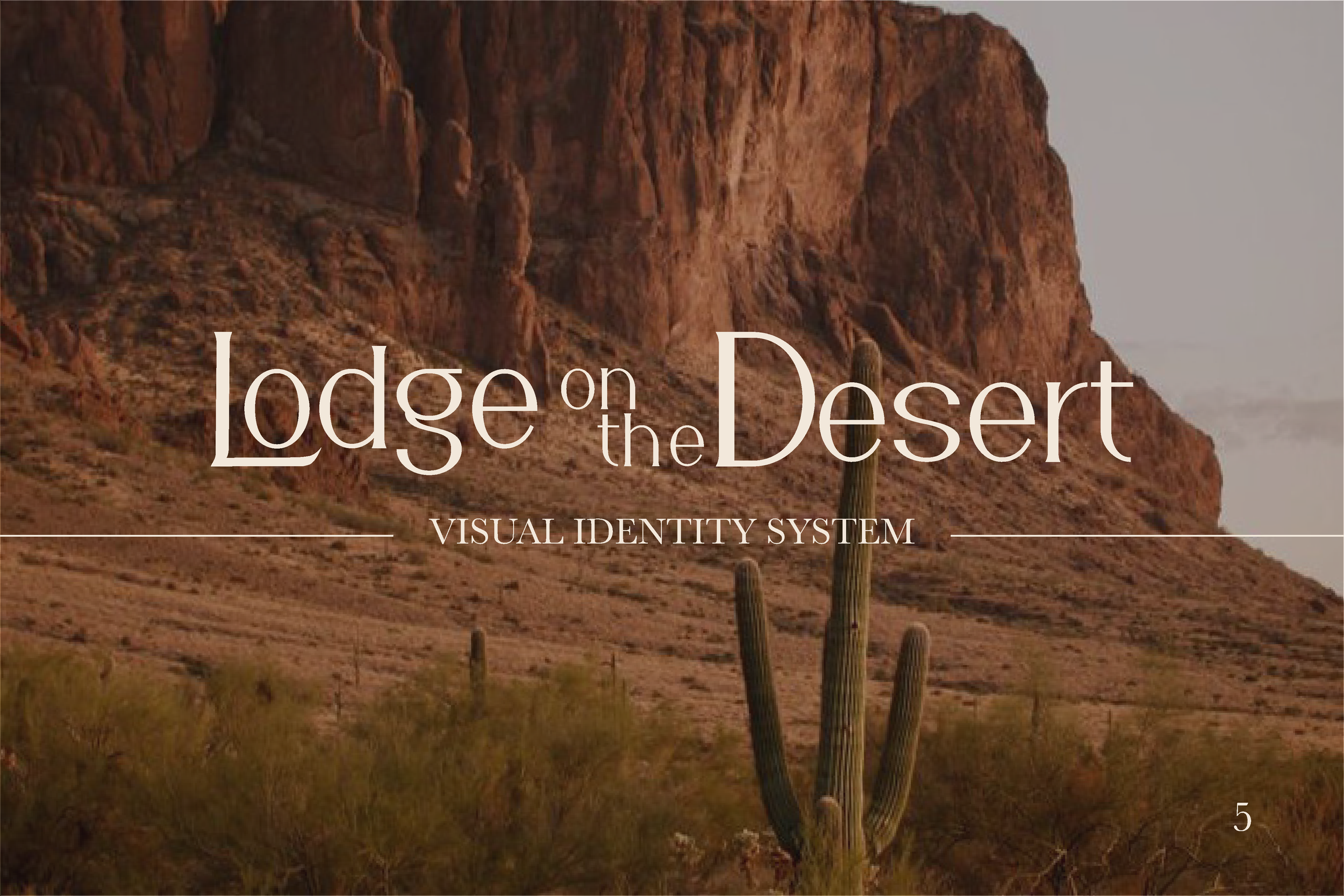 A desert landscape with a large rocky formation and saguaro cacti in the foreground.