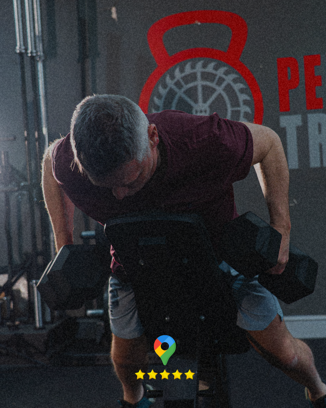 Male strength training in Stroud, lifting two dumbells