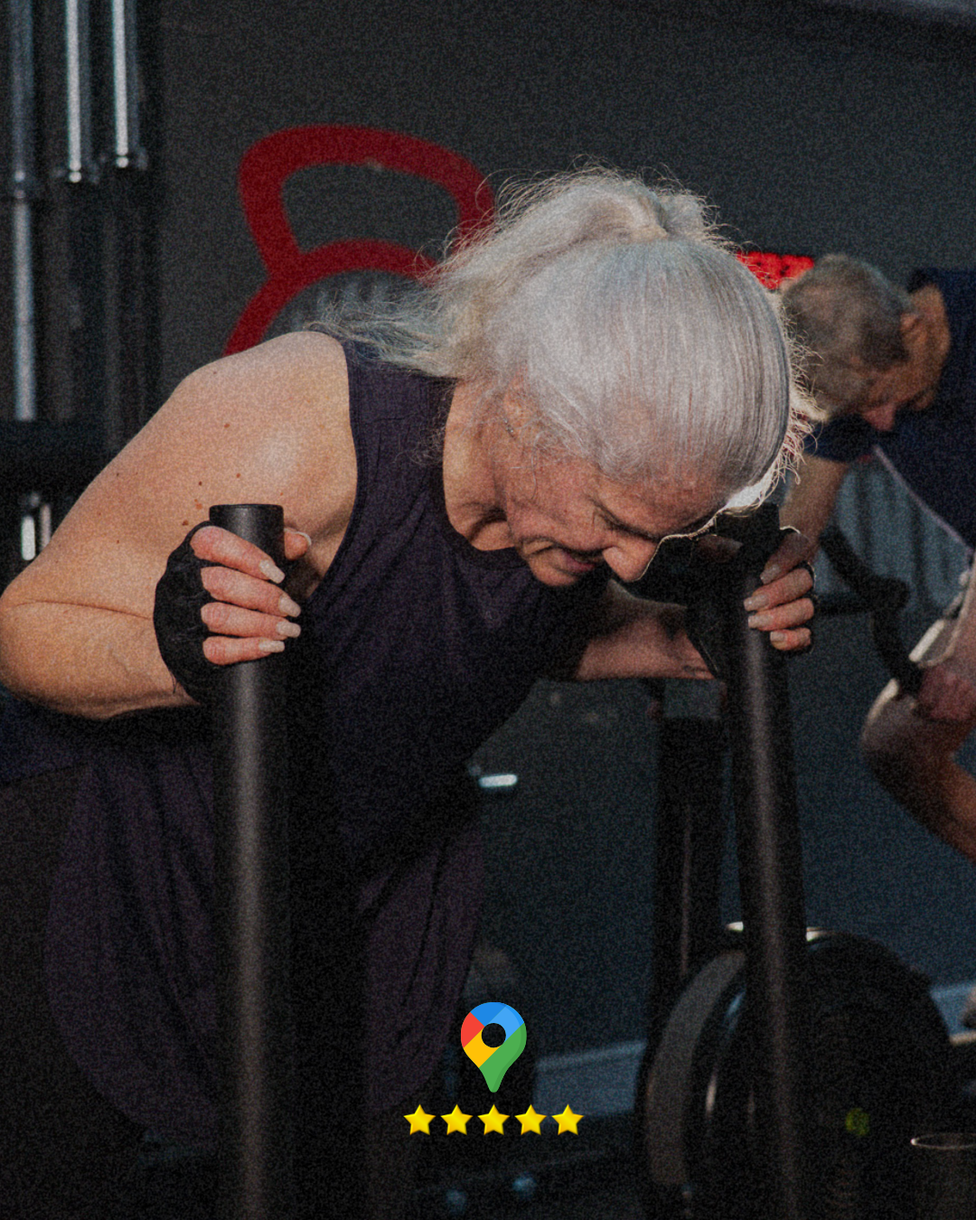 A middle-aged woman, pushing a sled in a gym.