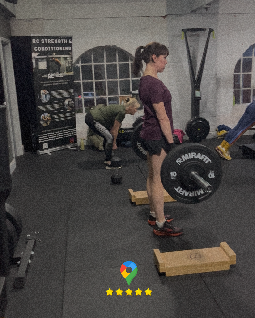 Two females strength training next to eachother. Both doing different exercises for personal trainnig.