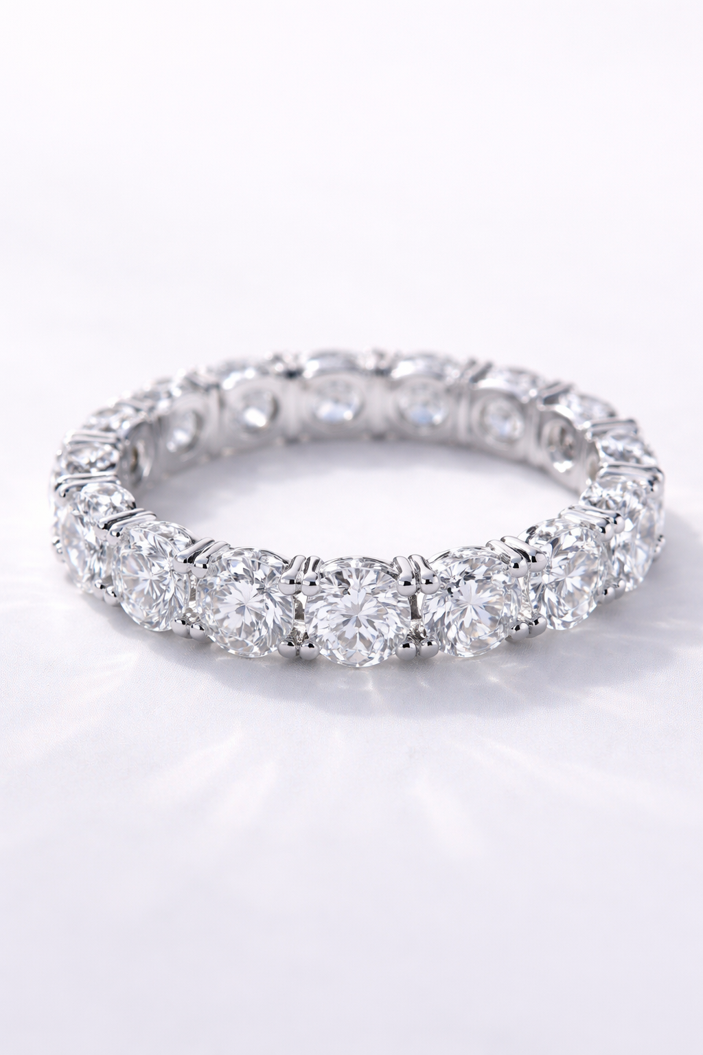 A silver eternity ring featuring large, round-cut diamonds set in a continuous circle.