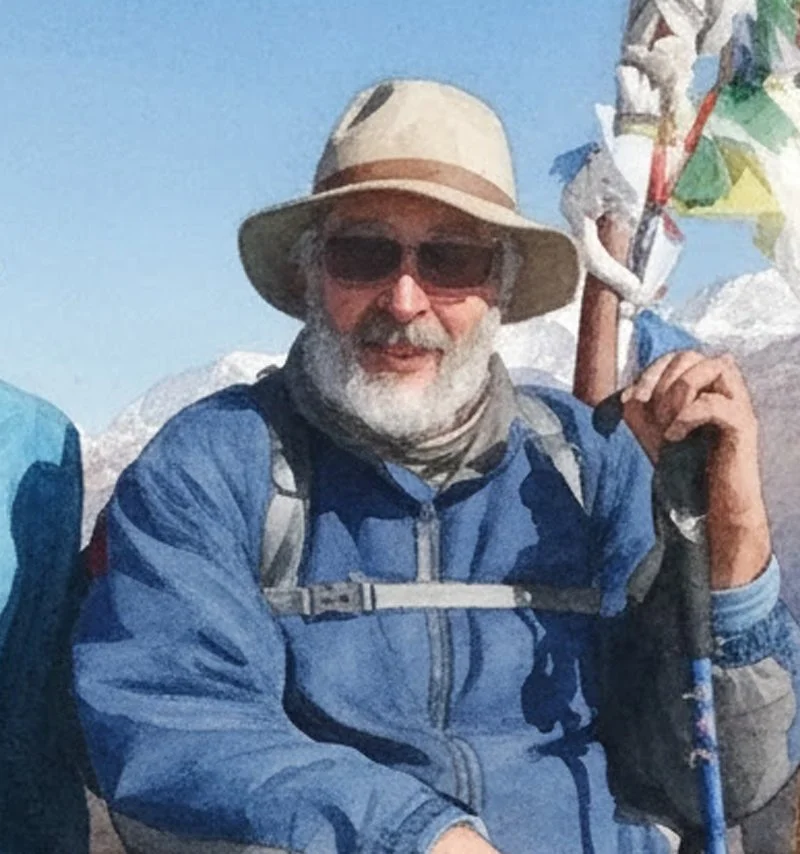 An elderly man with a white beard and mustache dressed in outdoor hiking gear, wearing a beige wide-brimmed hat and sunglasses, standing outdoors with mountains and snow in the background, holding a trekking pole, indicating he is on a mountain hike.
