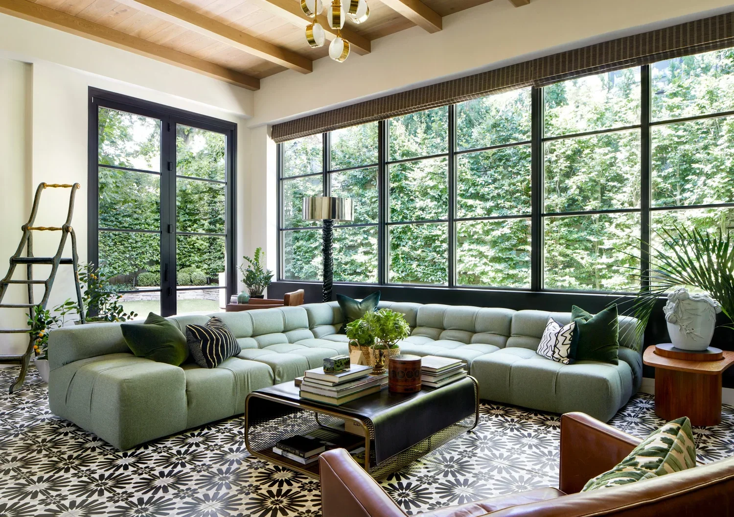 Living room with green sofa and large windows