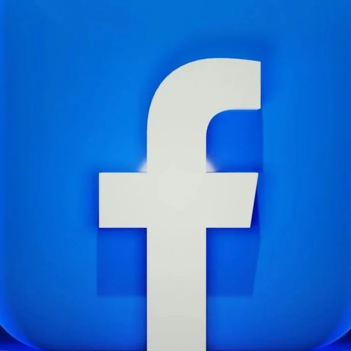 Close-up of Facebook logo on blue background.