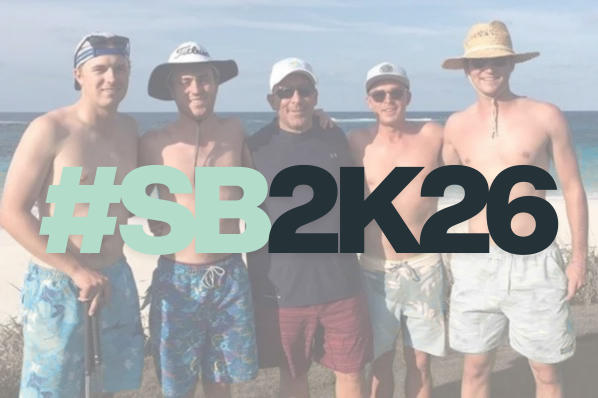 Five men dressed in swim trunks and hats posing together on a beach, with a large hashtag and text overlay reading #SB2K26.