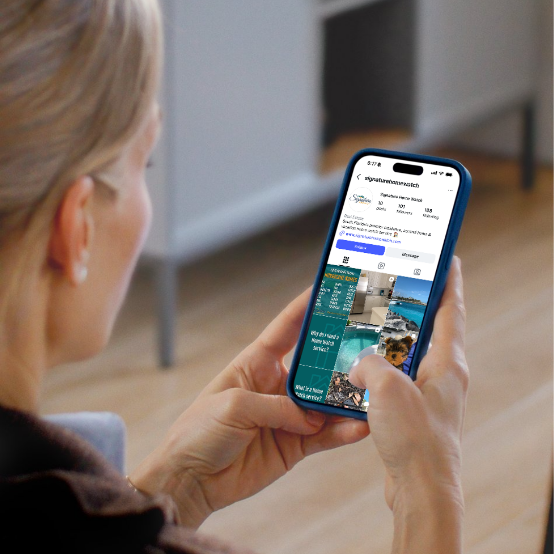 A woman with blonde hair looking at a smartphone displaying a social media profile for Signature Home Watch, showing pictures and information about home watch services.