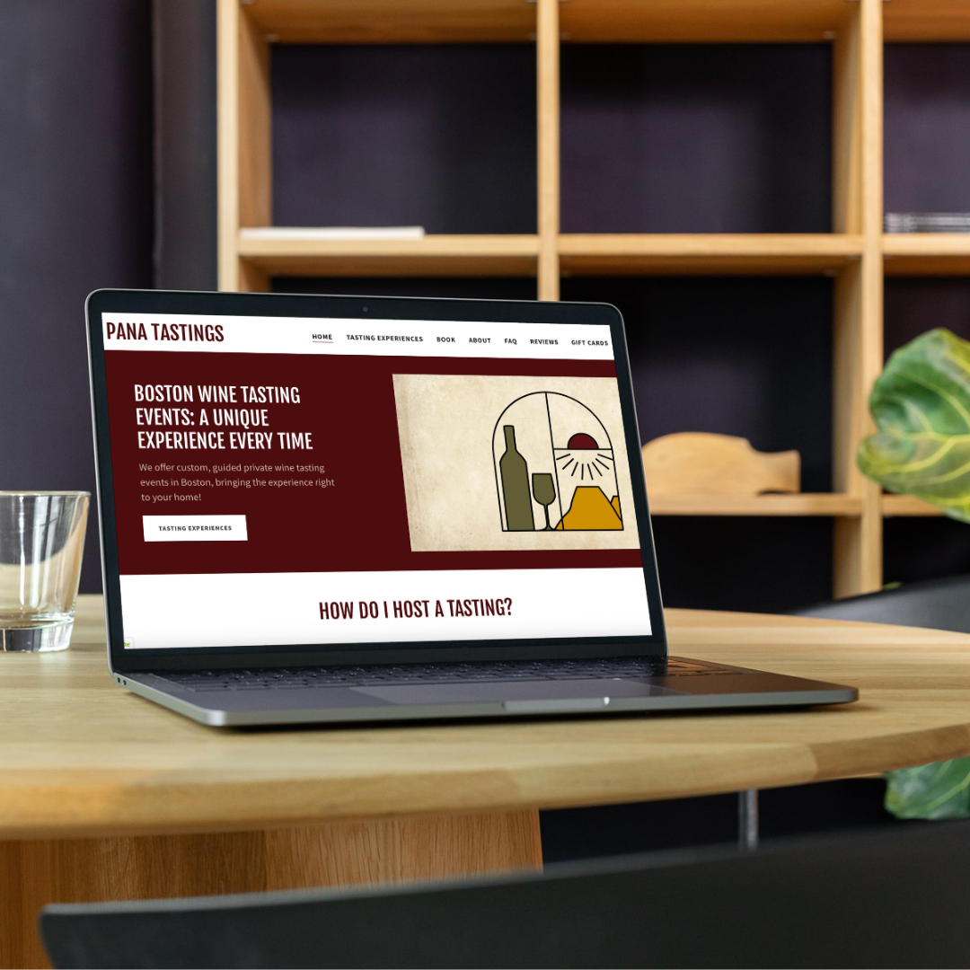 Laptop on a wooden table displaying a webpage for Pana Tastings, featuring Boston wine tasting events and a wine illustration.