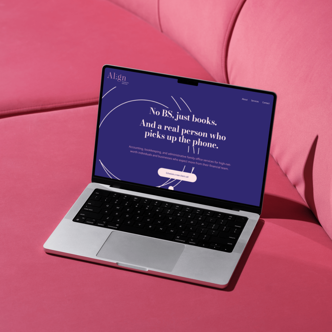 Laptop on pink couch displaying a website with the headline 'No BS, just books. And a real person who picks up the phone.'