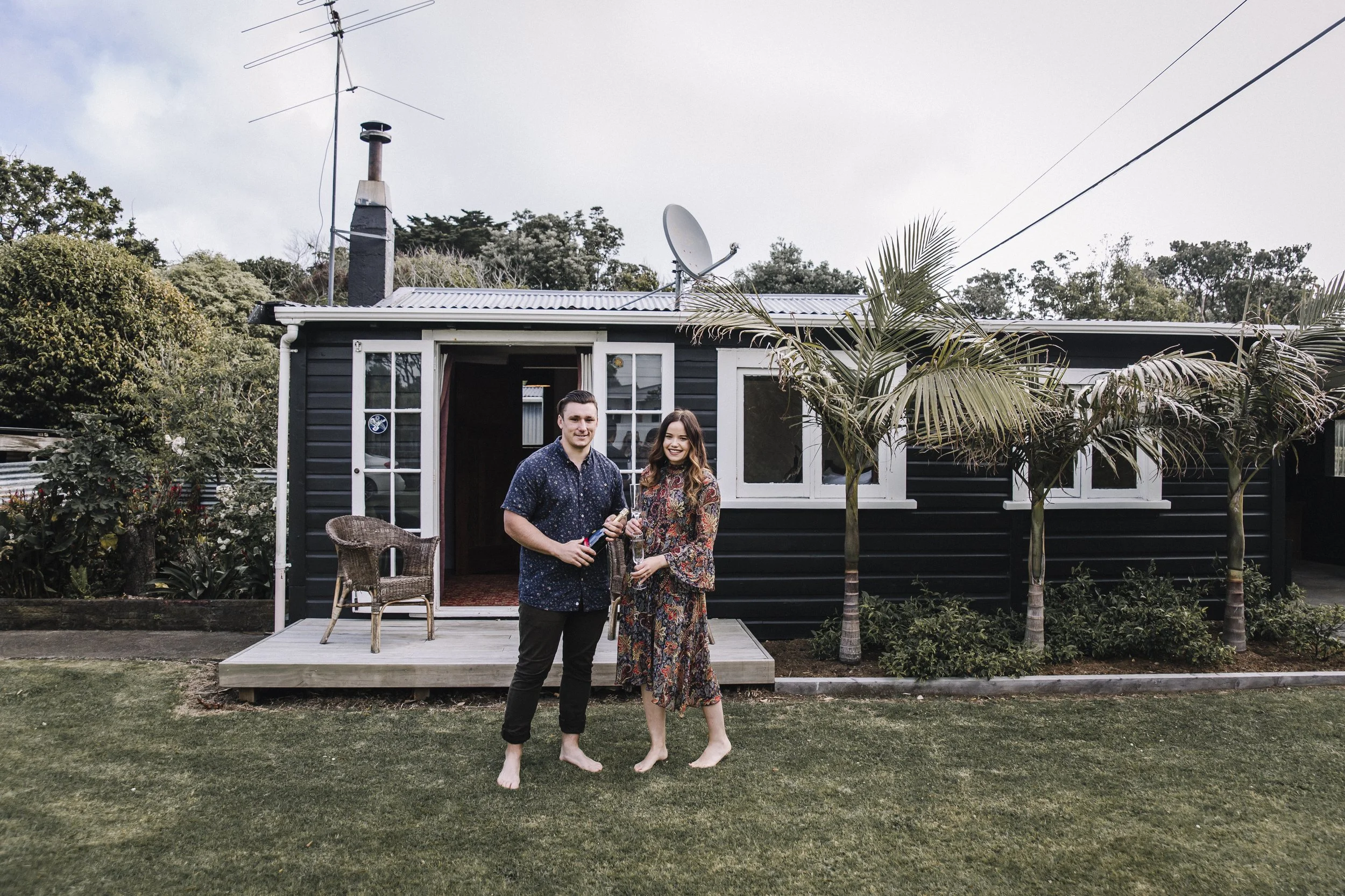 Thomas Watt & Greer Garner outside Fox Cottage, award winning bach in Opunake