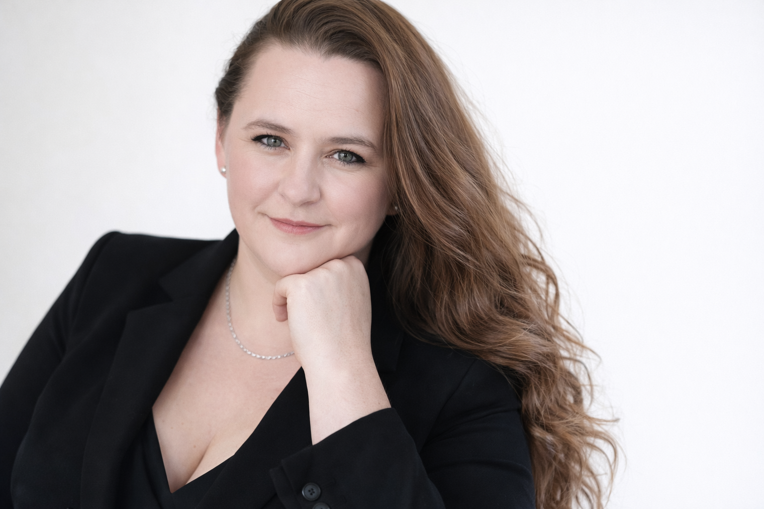 A Headshot of Marcie Macari in a black suit jacket