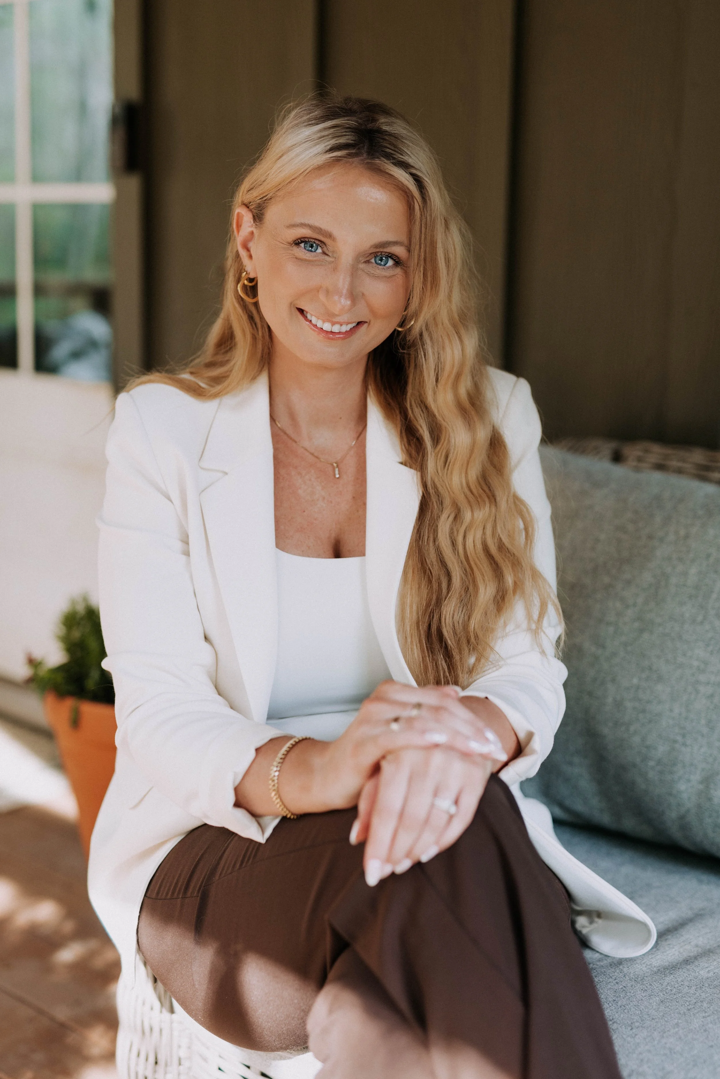 A marketing director woman sitting  with long blonde hair and a smile