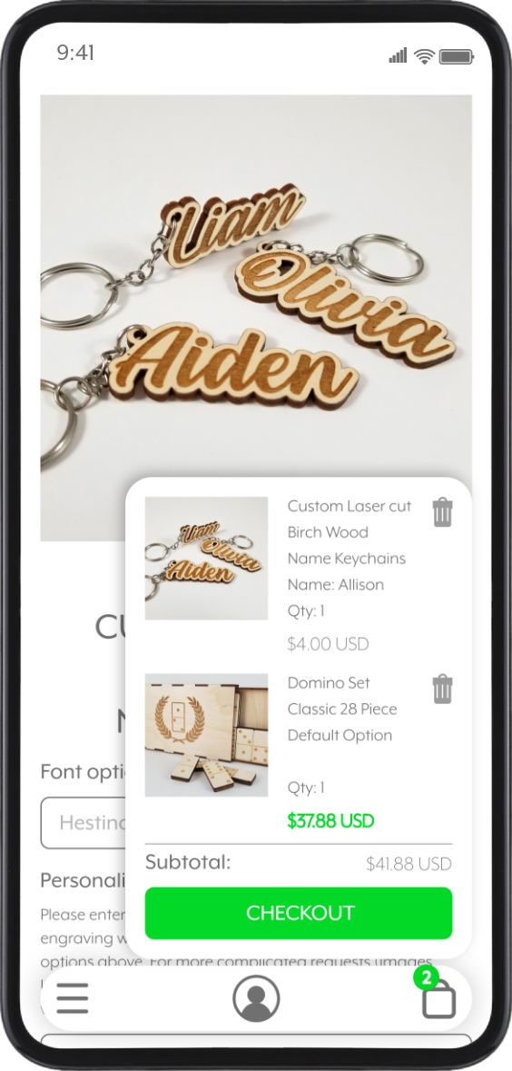 Mobile phone screen displaying close-up of customized birch wood name keychains with names Liam, Olivia, and Aiden, attached to silver key rings.