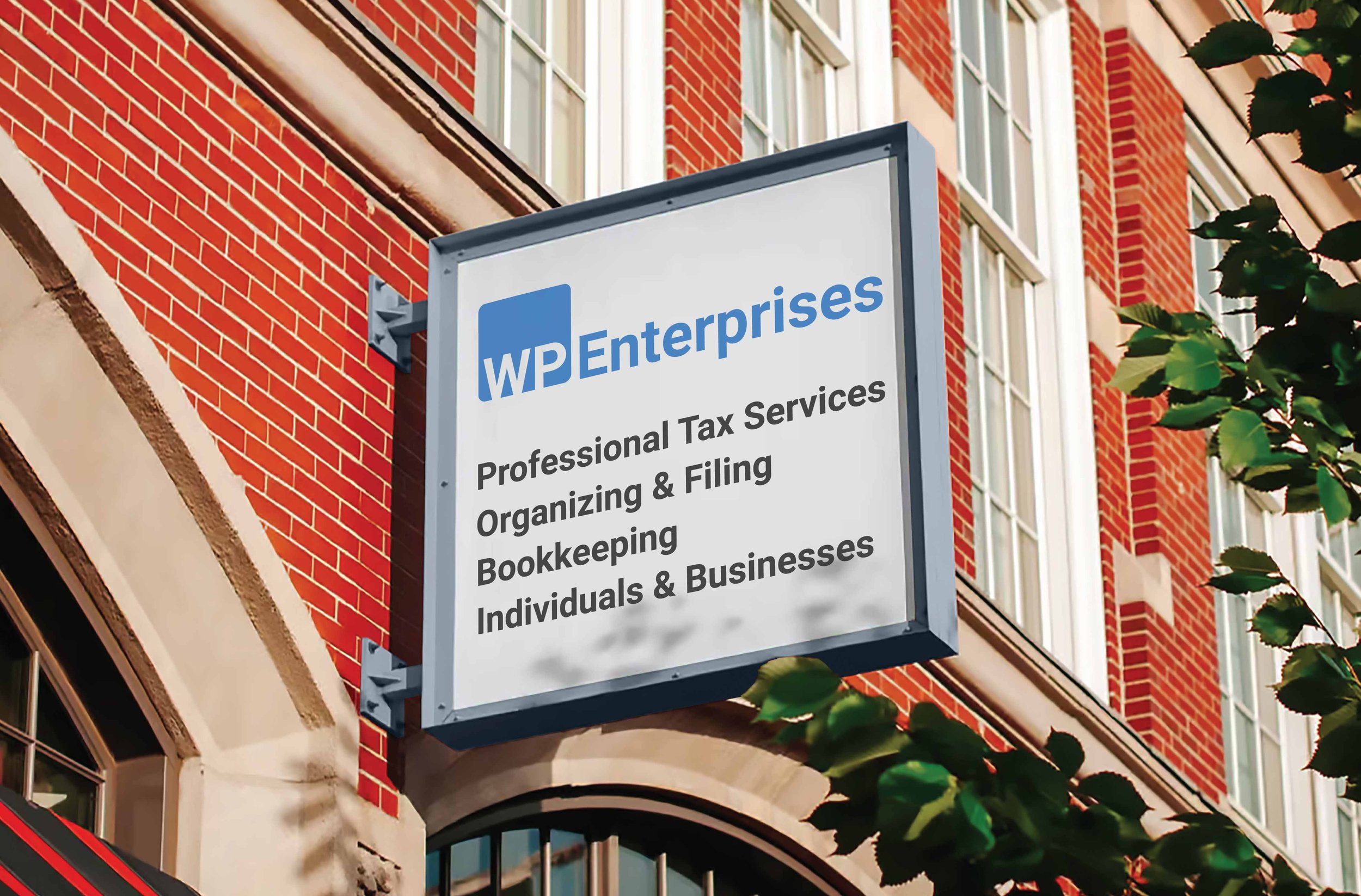 Sign for WP Enterprises providing professional tax services, organizing and filing, bookkeeping, and serving individuals and businesses, mounted on the exterior of a red brick building.