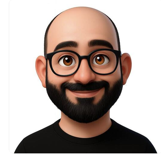 Animated cartoon of a man with a bald head, glasses, a beard, and a friendly smile. KYNDA CREATIVE TEAM.