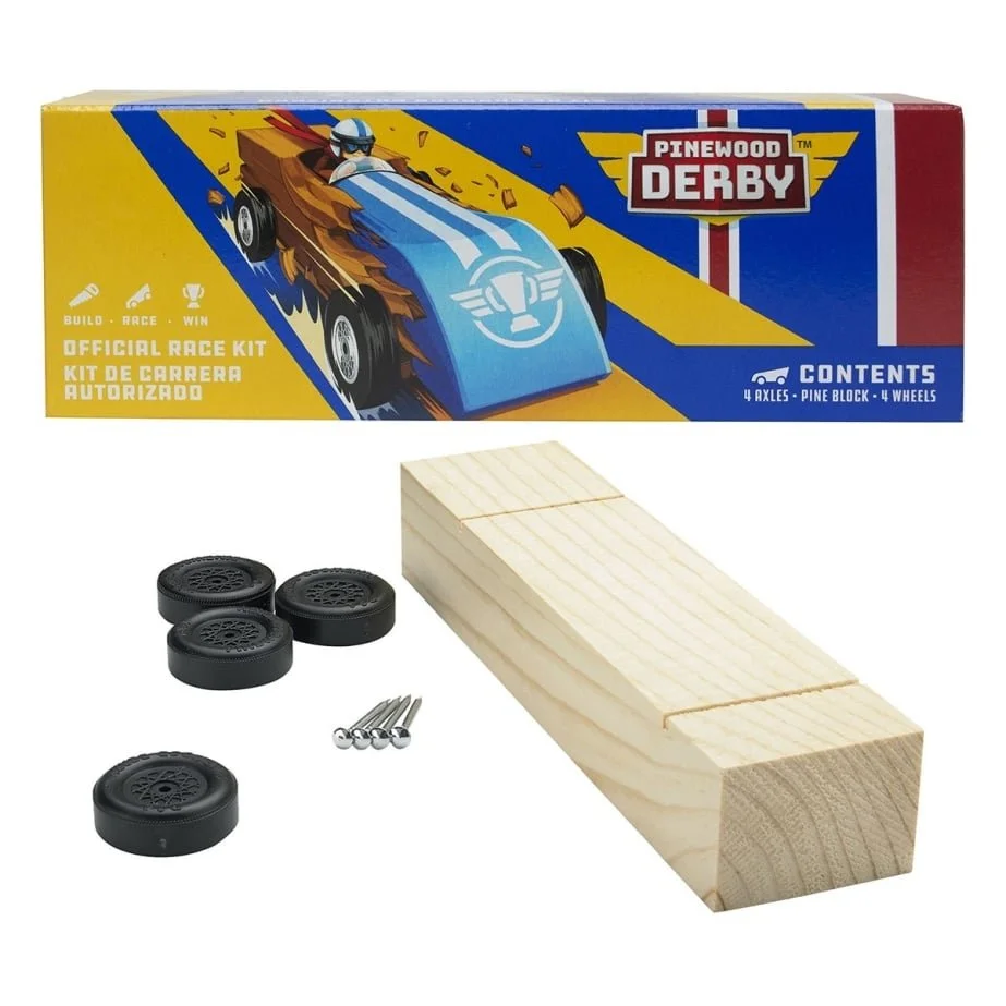 Kit for building Pinewood Derby race car with four wheels, four nails, and a wooden block, alongside a colorful box labeled 'Pinewood Derby'