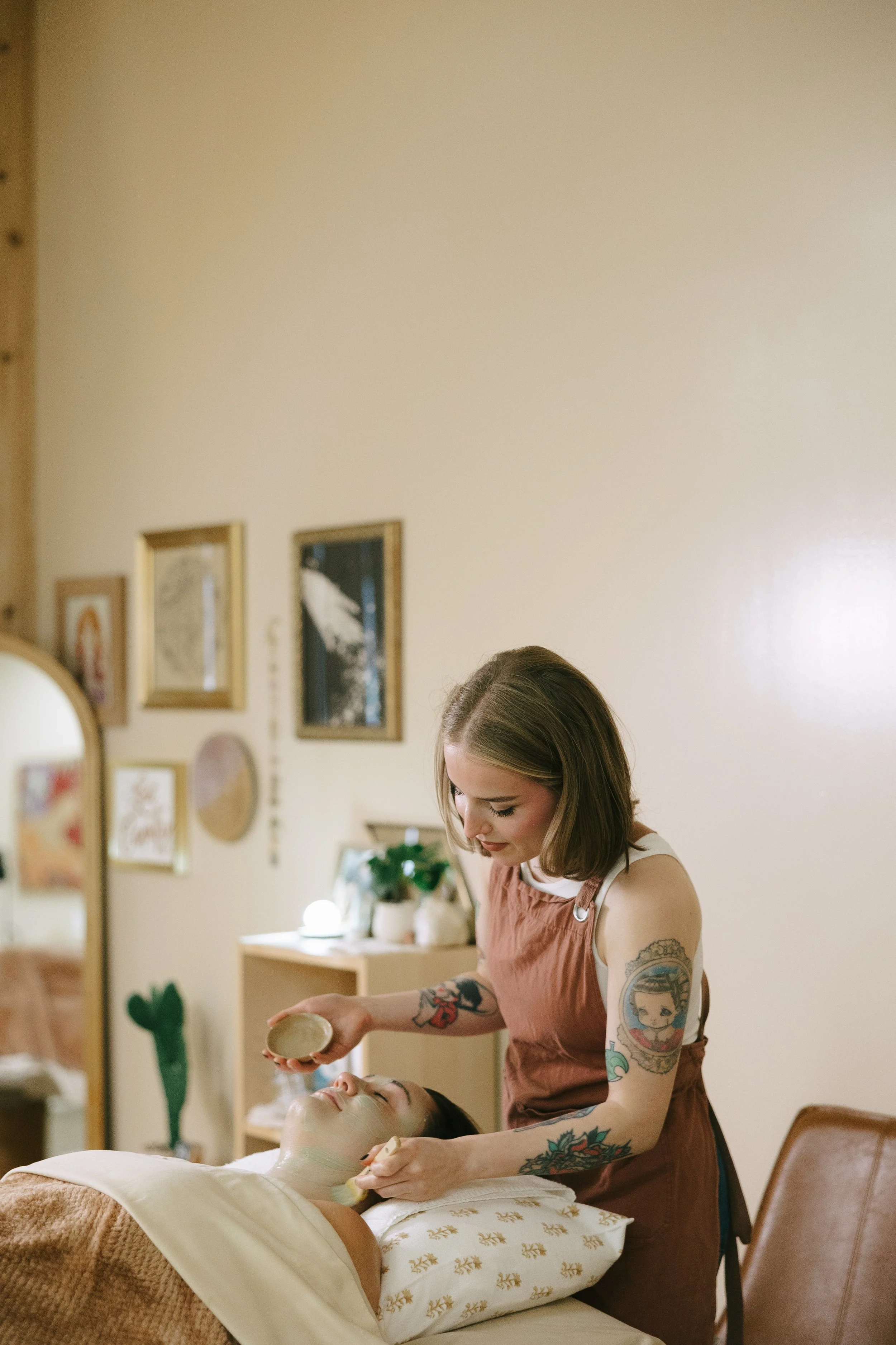 Emma (Esthetician) at Dahlia Beauty Bar giving a client a natural, corrective facial
