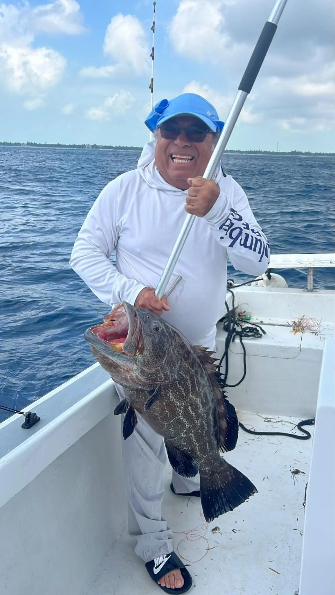 man catching a large fish in Belize