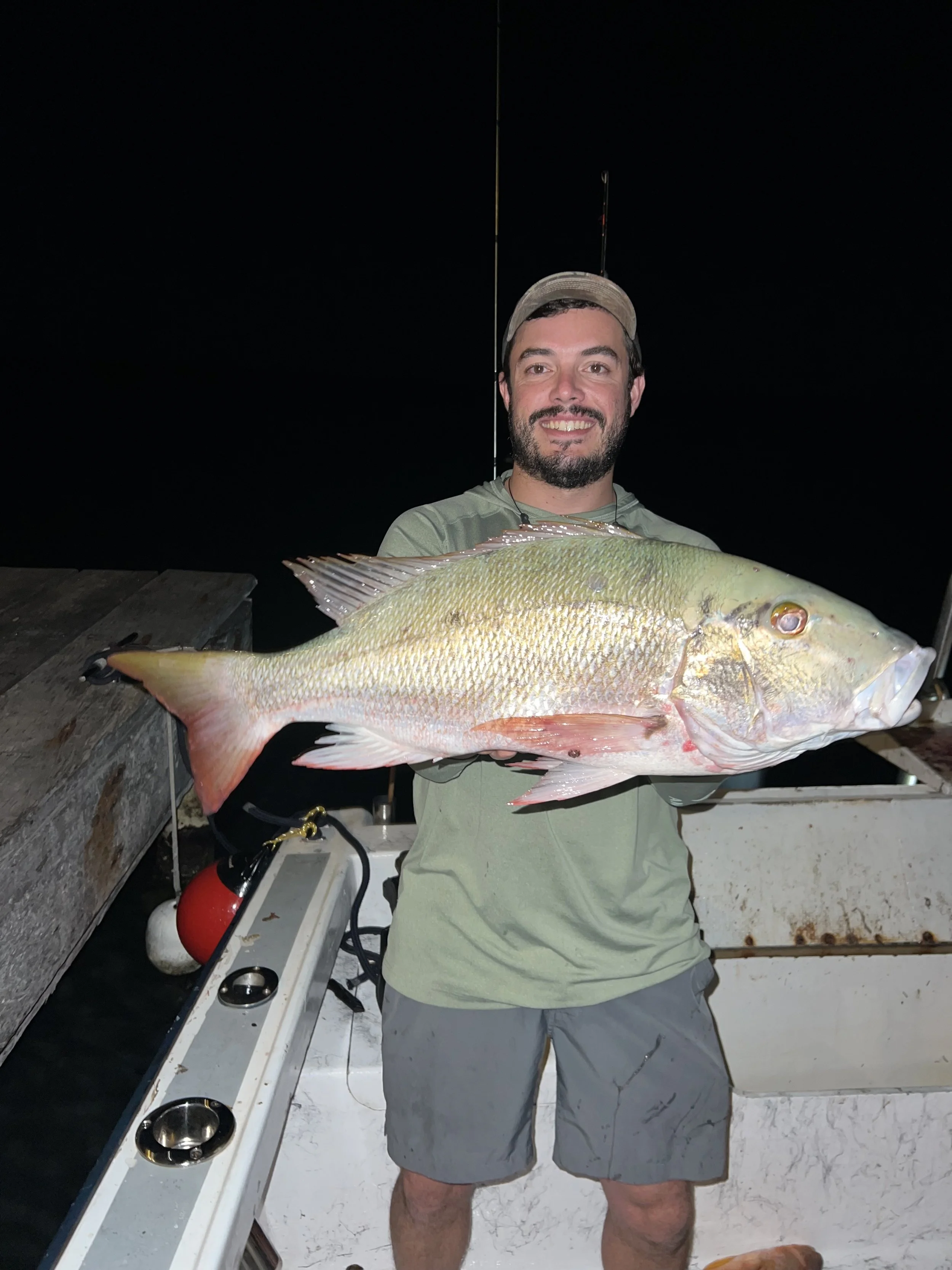man catched large fish at night in belize.