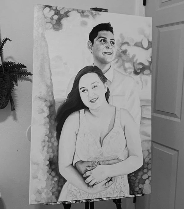 A black and white portrait painting of a smiling couple standing outdoors, with the woman in front and the man slightly behind her. The woman has long hair and is wearing a lace dress, while the man has short hair and is wearing a collared shirt. They are surrounded by trees and foliage.