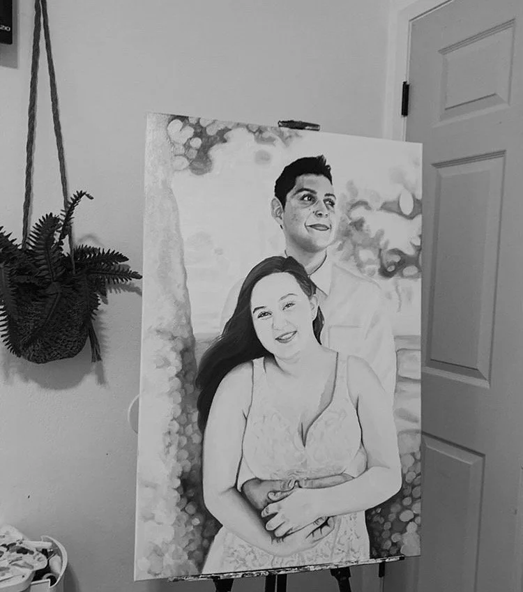 A black and white painting of a smiling woman with long dark hair and a man with short dark hair. The woman is in the front, wearing a sleeveless dress, and the man is behind her with one arm around her waist. They are outdoors with trees and sky in 