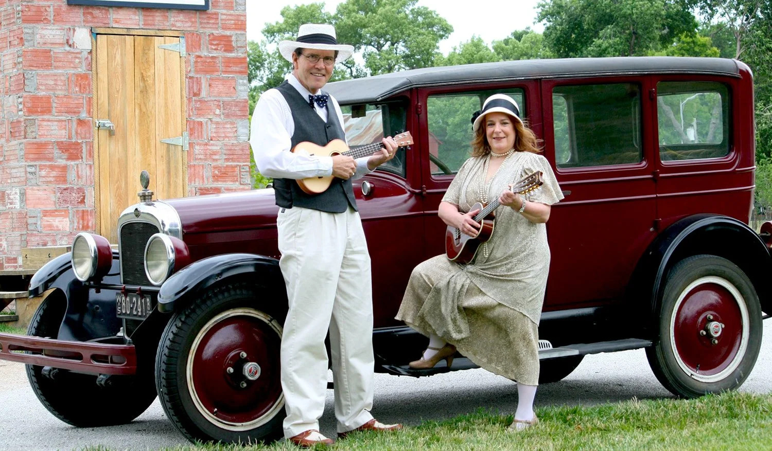 two volunteers in costume play ukuleles