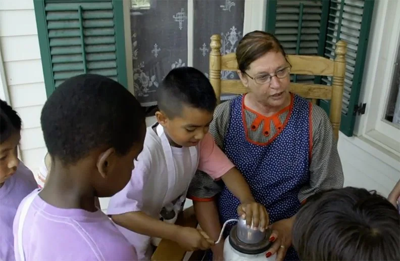 a volunteer works with kids at Shawnee Town