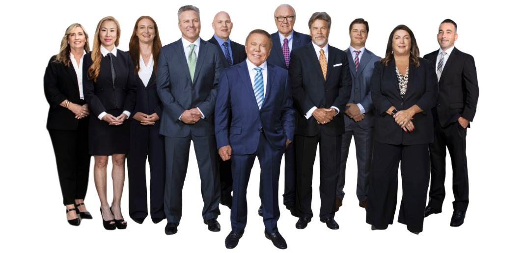 Group of 10 professionally dressed people standing together for a photo, smiling at the camera.
