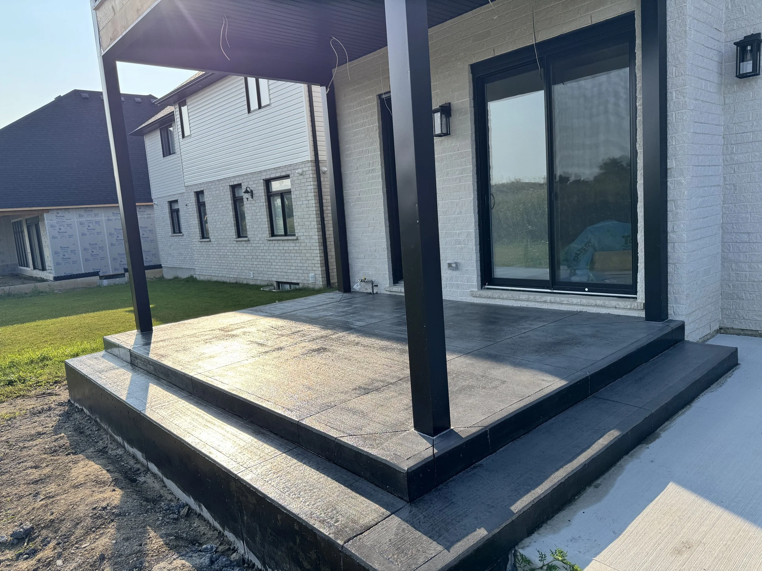 Newly constructed house with a small covered porch 