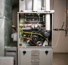 Open boiler with exposed internal components and wiring.