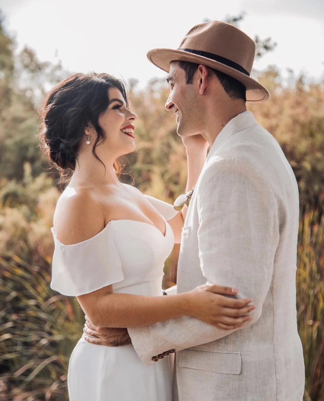 Bride with soft, radiant bridal makeup sharing an intimate moment with her partner, looking confident, elegant, and effortlessly beautiful