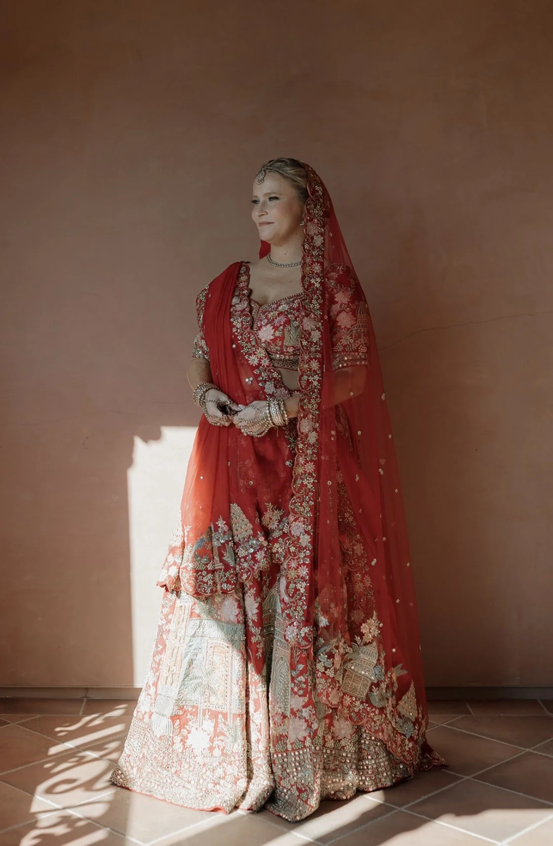 Bride in traditional Indian wedding attire with flawless, radiant makeup, showcasing a timeless and culturally inspired bridal look