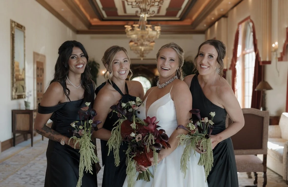 Bride and bridal party with cohesive, soft glam hair and makeup looking polished and confident in an elegant wedding setting